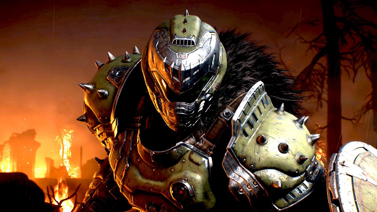 The Doom Slayer standing in front of fire in the FPS game, Doom: The Dark Ages.